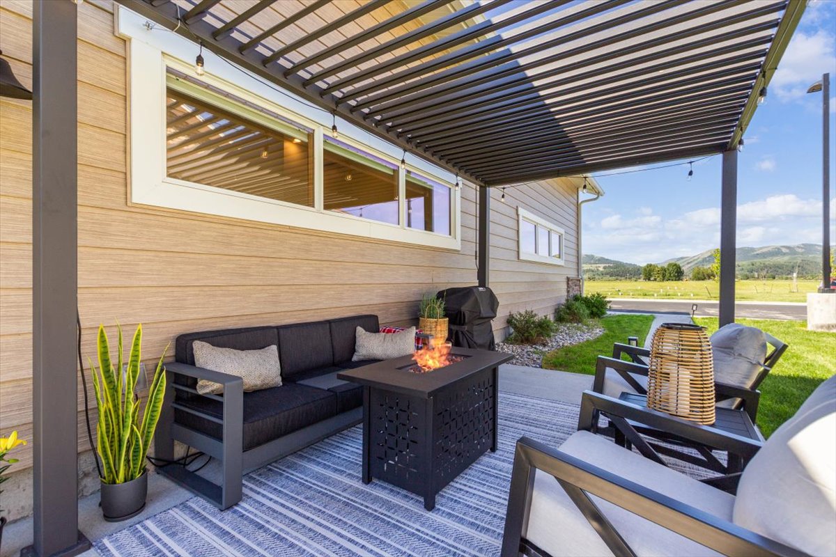 Outdoor lounge seating under the pergola with string lights