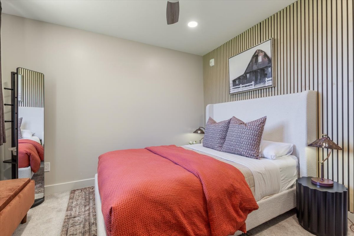 Main bedroom with queen bed and slatted accent wall
