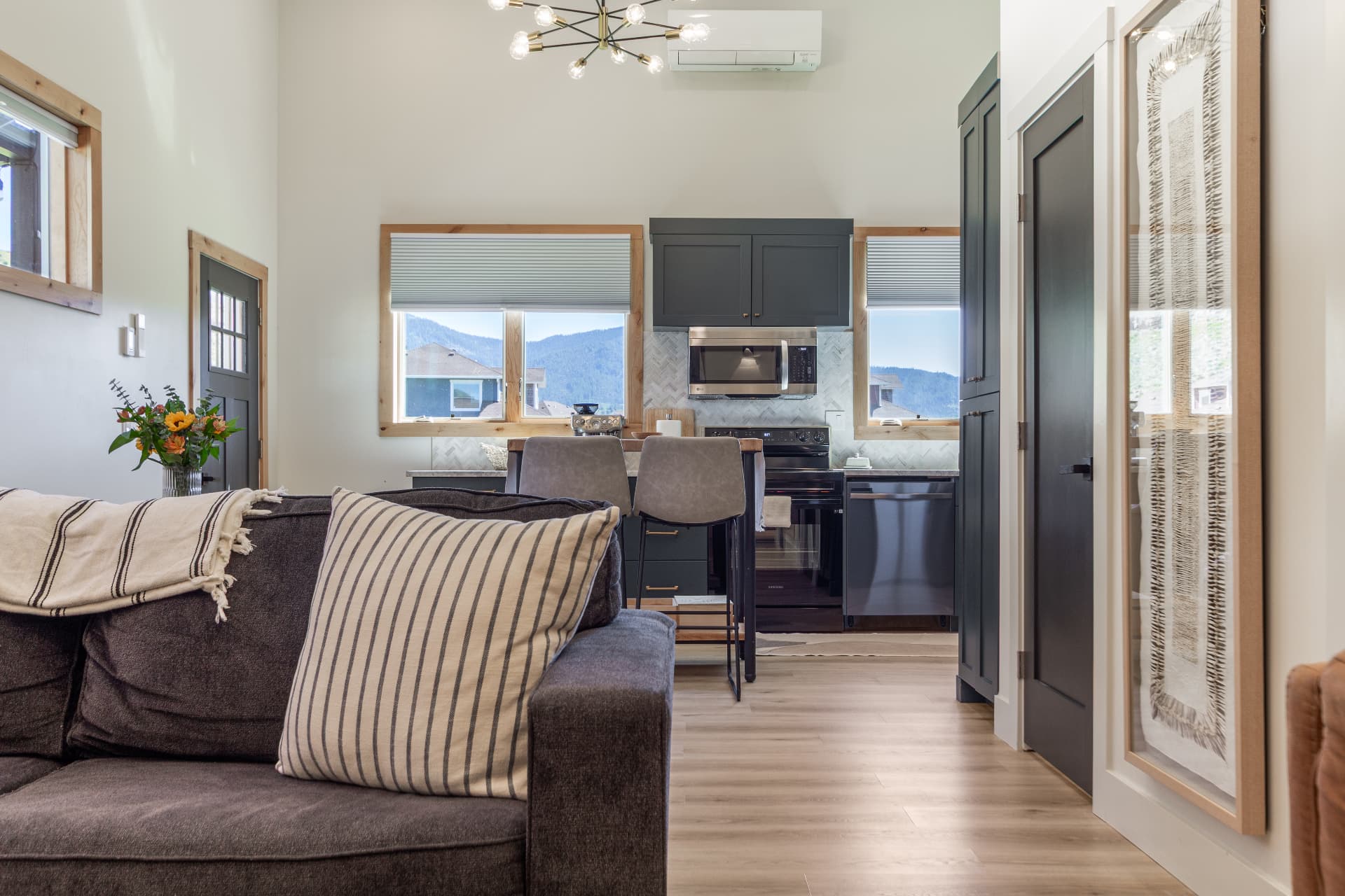 View from the living room sofa toward the kitchen and mountain views