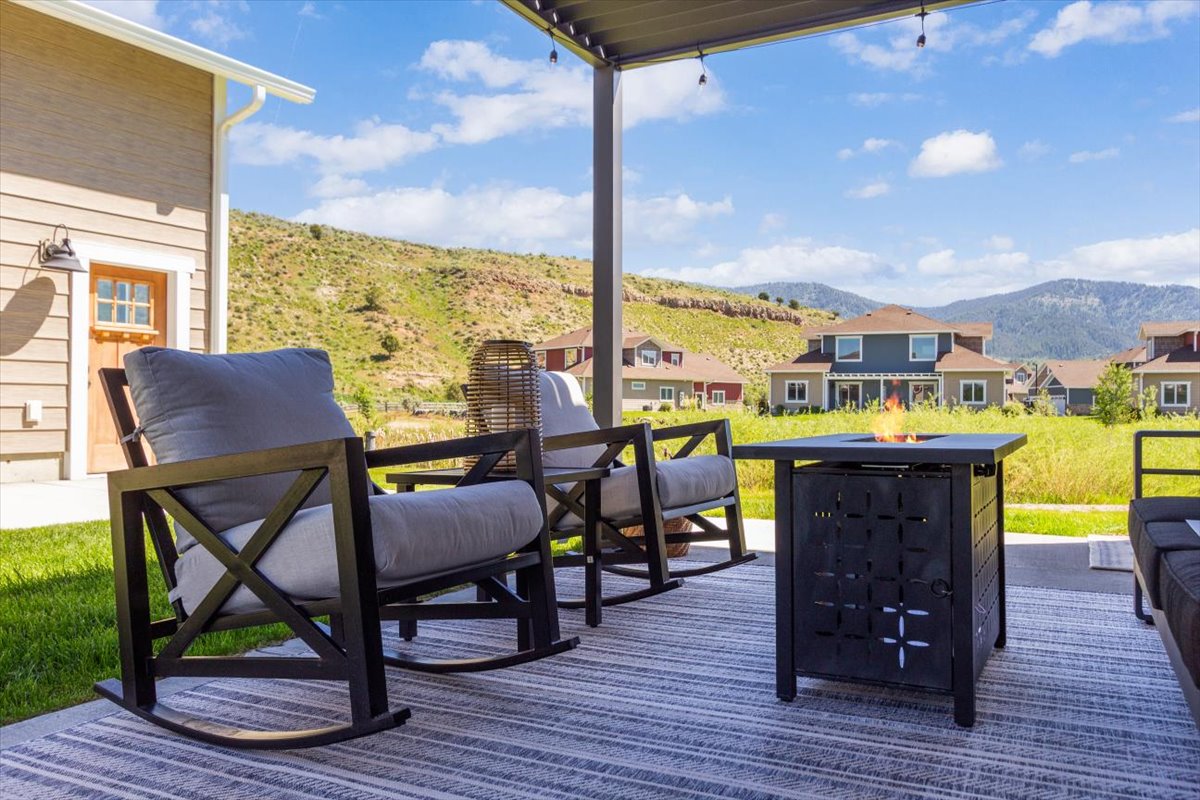 Rocking chairs around a gas fire pit on the patio