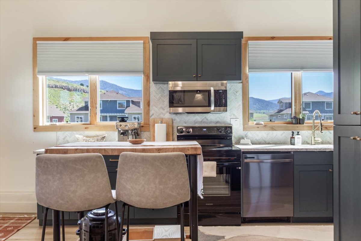 Kitchen with butcher-block island and mountain views from both windows