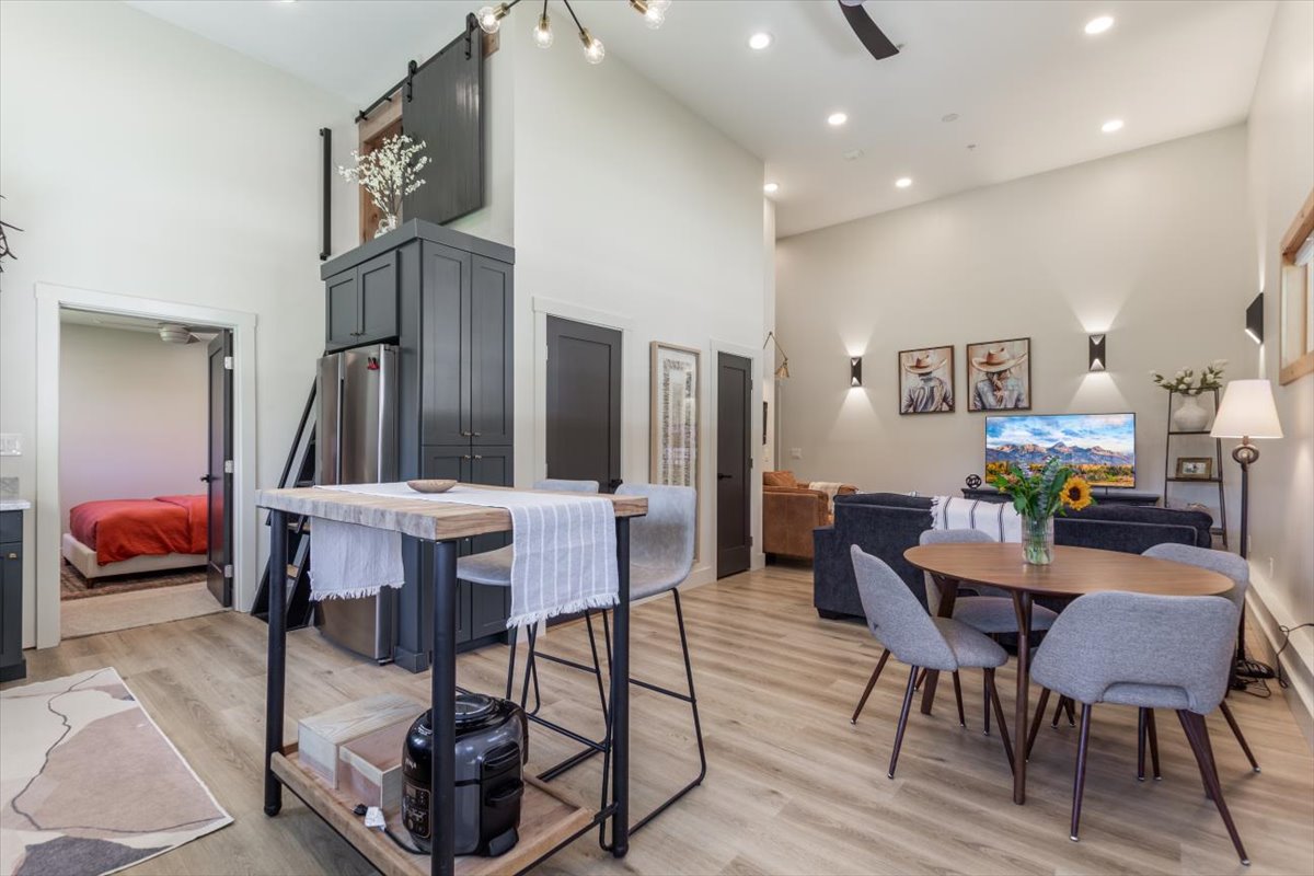 Open-concept living and dining area with vaulted ceilings
