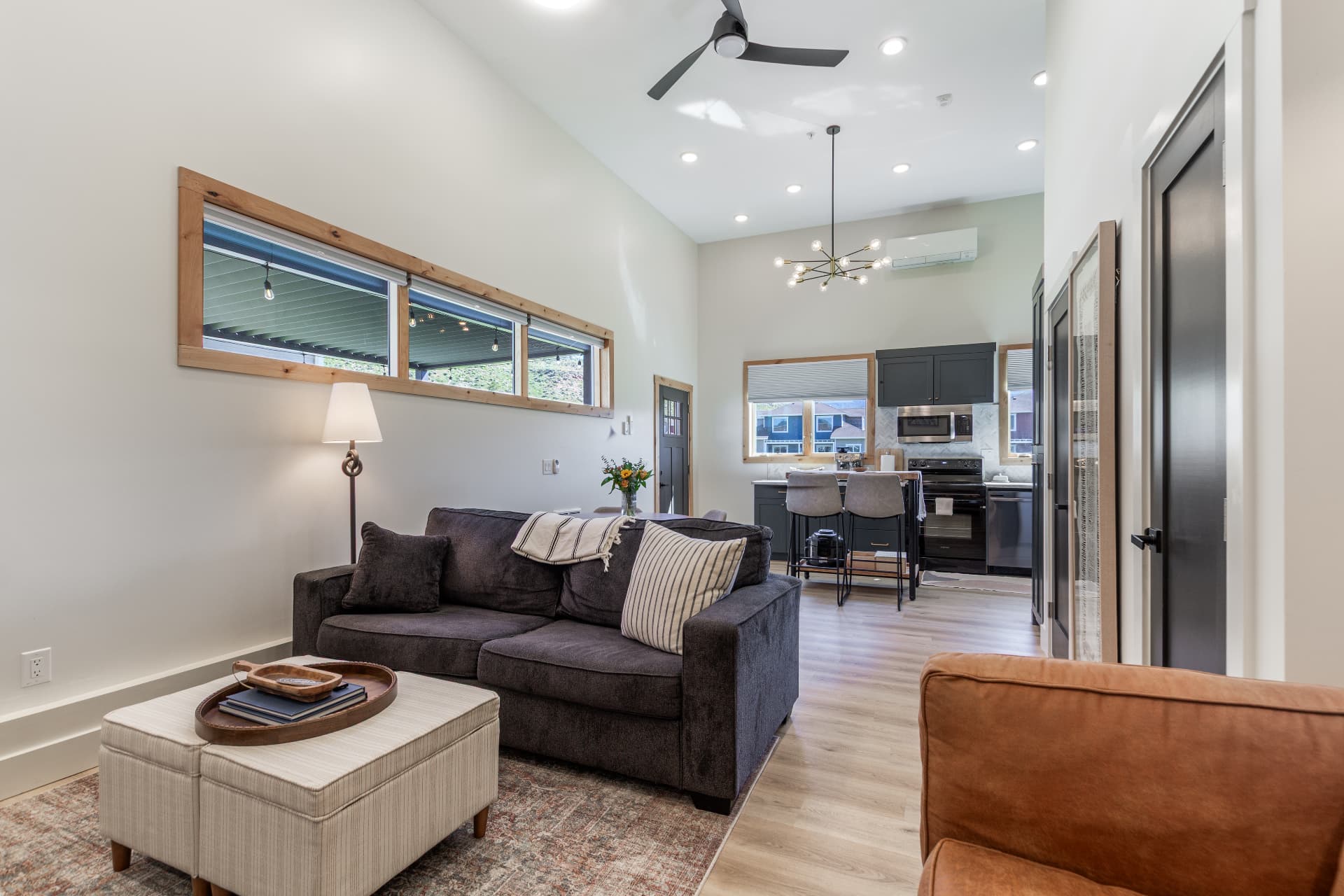 Living room sofa and ottoman under vaulted ceilings with clerestory windows